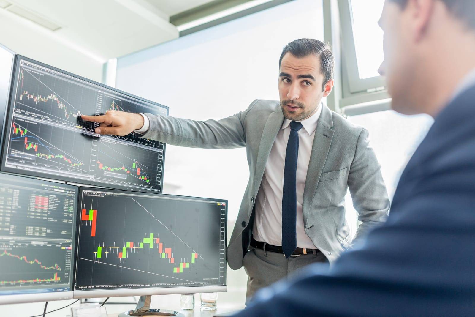 Stock Brokers Looking At Computer Screens, Trading Online. 