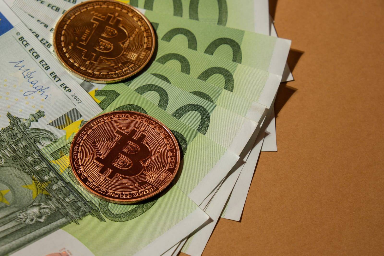 Bitcoin Gold Coin On Bills Of 100 Euros Eu Currency. Bitcoin Mining Trading Concept. BTC Golden Money Spinning Around. Worldwide Virtual Internet Cryptocurrency Or Crypto Digital Payment System 