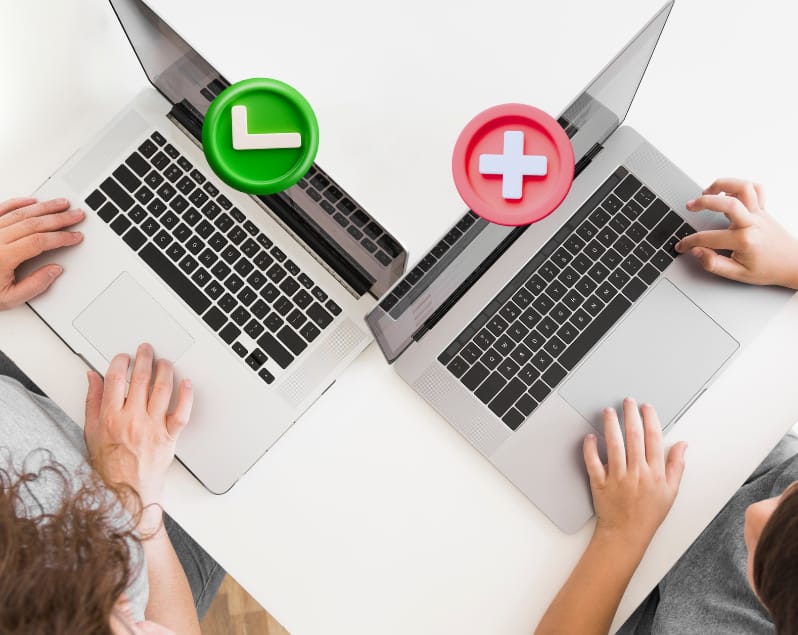 Bird's eye view of laptops with check and cross graphic icons placed on each laptops.