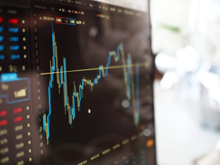 A laptop screen showing a detailed candlestick patterns and trends.