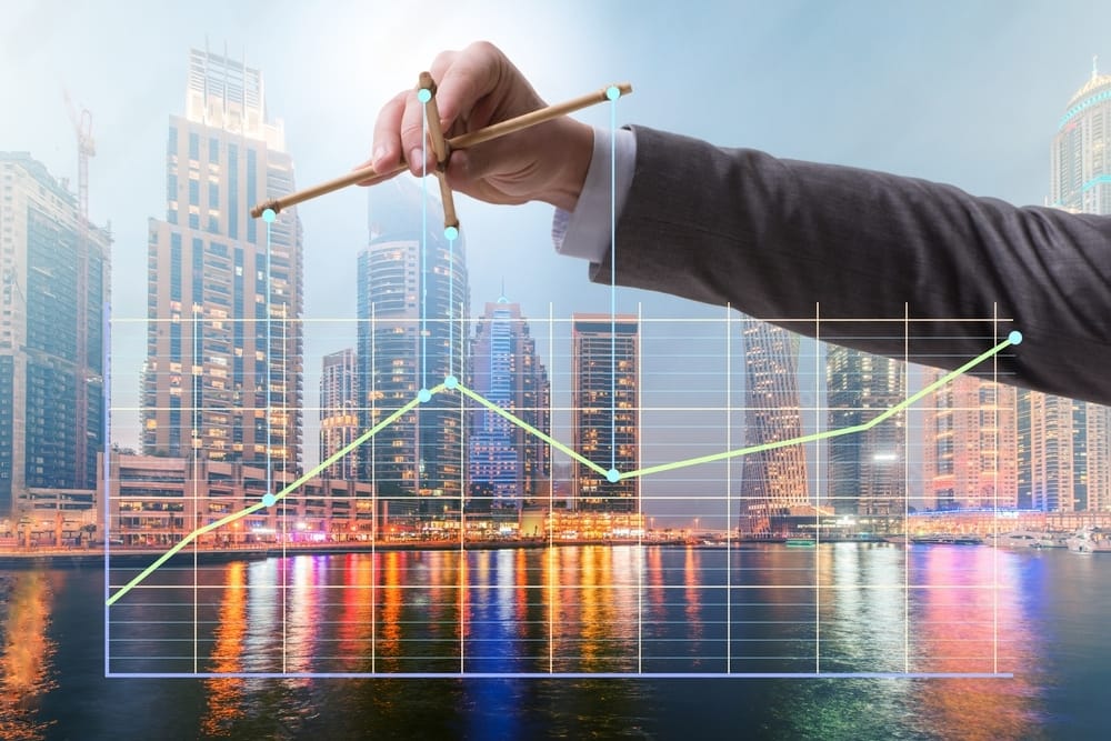 A hand in suit manipulting the trading graph as if playing a marionette.