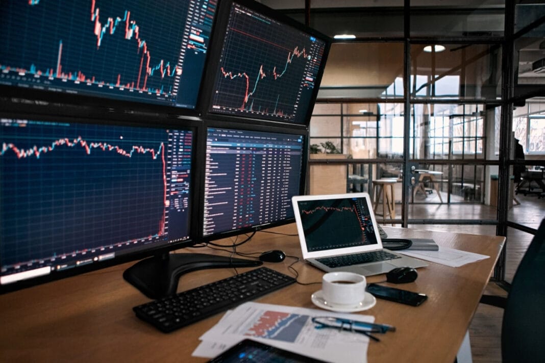 Arangements of PC screens showing inside candle graphs and trends.